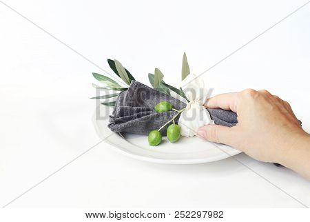Woman Hand Holding Grey Linen Napkin Decoted By Olive Branch And Silk Ribbon. Festive Table Summer S