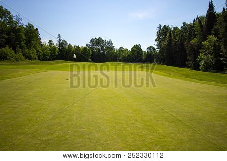 The 18th Hole. Putting Green And Fairway At The 18th Hole On A Sunny Summer Day.