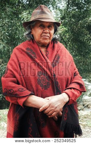 Mongui, Boyaca / Colombia - Feb 18 2016: Lady In Traditional Hat And Poncho In Front Of Eucalyptus T