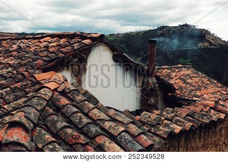 Mongui, Boyaca / Colombia - Feb 18 2016: Old Ceramic Tiles On A Traditional Home With A Small Chimne