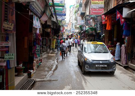 KATHMANDU, NEPAL - JULY 17, 2018: Street in the Thamel district, Kathmandu. Thamel is a tourist district with many hotels, souvenir shops, restaurants and nightlife