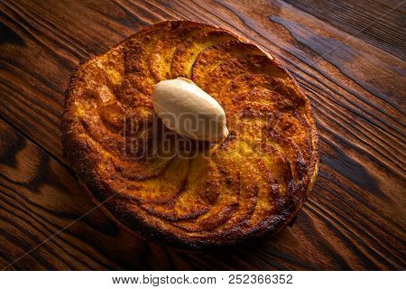 Apple tatin pie cake on puff pastry dessert and ice cream on top