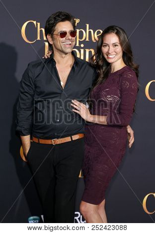 John Stamos and Caitlin McHugh at the Los Angeles premiere of 'Christopher Robin' held at the Walt Disney Studios in Burbank, USA on July 30, 2018.