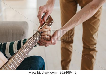 Learning To Play The Guitar. Music Education And Extracurricular Lessons.