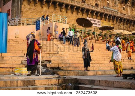 VARANASI, INDIA - MAR 21, 2018: Sadhu or Baba (holy man) on the ghats of Ganges river. Normally a sadhu is a monk, renounced, renounced material enjoyment. In India from 4 to 5 million sadhu.