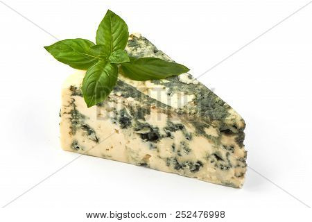 Wedge Of Soft Blue Cheese With Mold And Basil Leafs Isolated On White Background