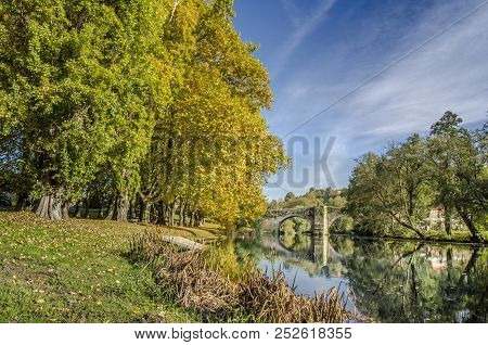 Medieval Bridge Over Arnoia River In Allariz, Ourense, Spain, In Autumn