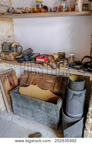 Lania, Cyprus - May 13, 2018: Shelving Full Of Tins And Jars Belonging To A Shoe Maker, Preserved In