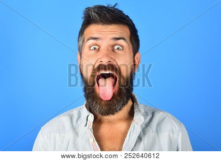 Happy Bearded Man. Bearded Man With Long Beard And Moustache Shows Tongue. Man With Long Beard And M
