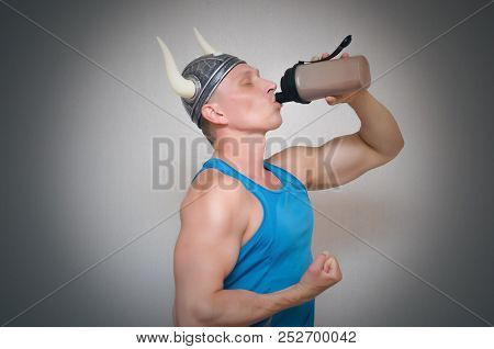 Bodybuilder Man In Viking Hat Is Drinking A Protein Cocktail From The Shaker And Get A Super Power I