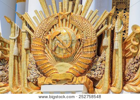 Moscow, Russia - August 01, 2018: Gilded Coat Of Arms Of Ussr Closeup On The Facade Of Pavilion Cent