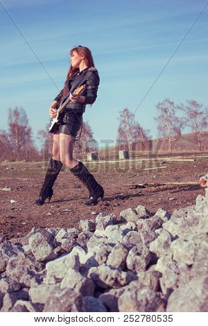 Beautiful Girl In Leather Jacket With Guitar