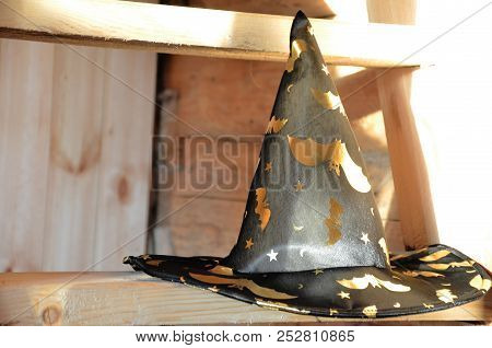 Halloween Witch Hat On Pumpkin Wooden Staircase Lying On Straw