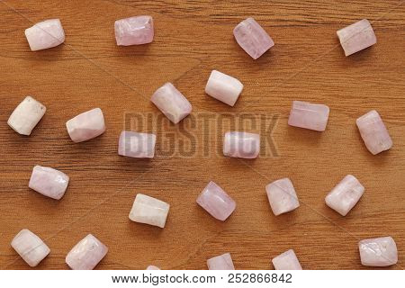 Kunzite Is A Natural Pink Stone For Creating Jewelry On A Natural Wooden Background. Natural Crystal