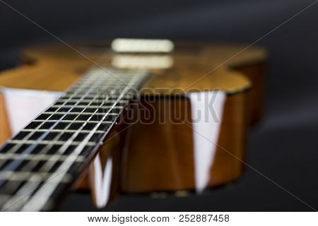 Part Of A Orange Acoustic Guitar On Black Background Close-up Shot Swallow Fod