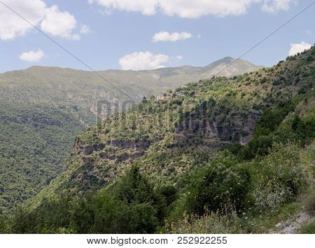 View Of The Traditional, Greek Village Kalarrytes Which Is On The Mountain Baros At An Altitude Of 1