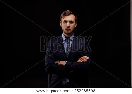 A Serious Man In A Black Suit. Black Background.