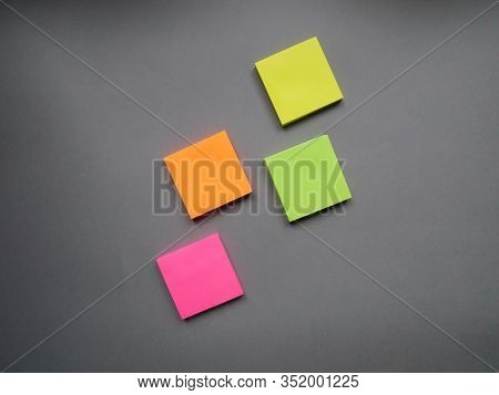Collection Of Different Colored Sheets Of Note Papers Ready For Your Message. Isolated On Gray Backg