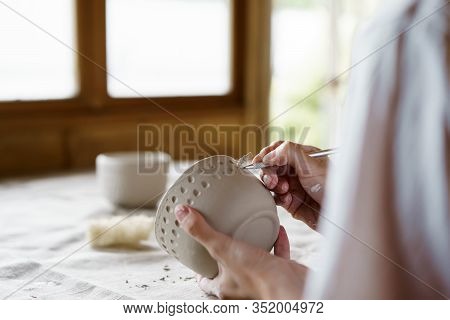 Female Hands Hold A Bowl For Casting Clay Products