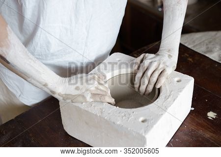 Female Hands Hold A Bowl For Casting Clay Products