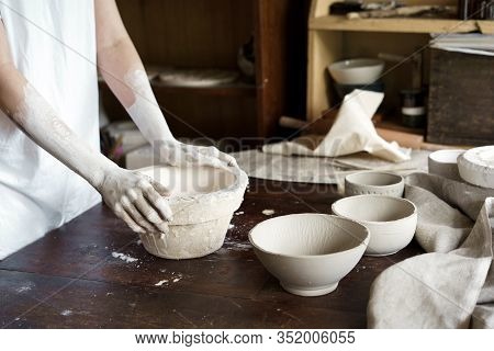 Female Hands Hold A Bowl For Casting Clay Products.