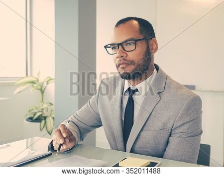 Focused Business Professional Listening To Speaker During Meeting Or Conference. Businessman Sitting