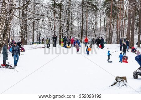 Moscow, Russia - January 12, 2020: People Walk And Play On Snow-covered Hills In Timiryazevsky Park 
