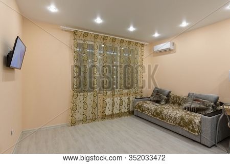 The Interior Of A Spacious Room With Modest Furniture