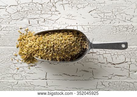 Heap Of Uncooked, Raw Freekeh Or Firik, Roasted Wheat Grain, In Metal Scoop On White Rustic Table Ba