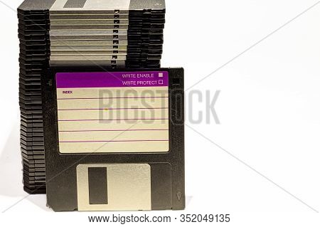 Numerous Black Floppydisks Lined Up On A White Background
