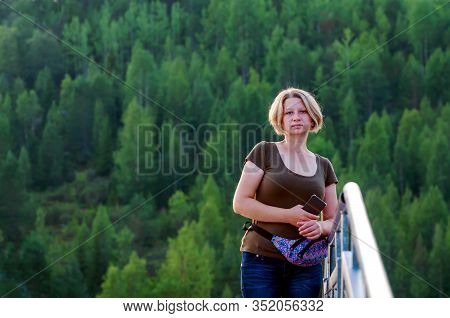 Portrait Of An Adult Woman On A Background Of Dense Green Forest. The Concept Of Man In A Healthy, E