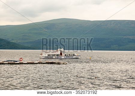 Luss, Scotland - August 1, 2019: A White Cruise Ship  At Loch Lomond Lake In Scotland