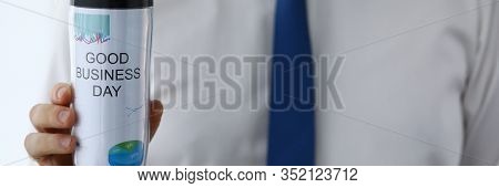 Man Hold In Hand Thermal Flask With Hot Beverage Closeup. Good Business Day With Coffee Drink Concep