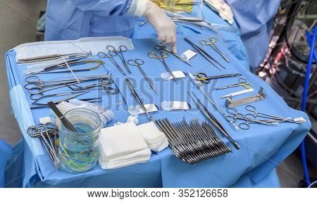 Surgical Instruments In Operating Room On Table.