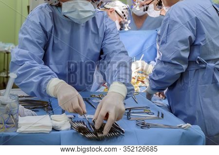 Surgical Instruments In Operating Room On Table.