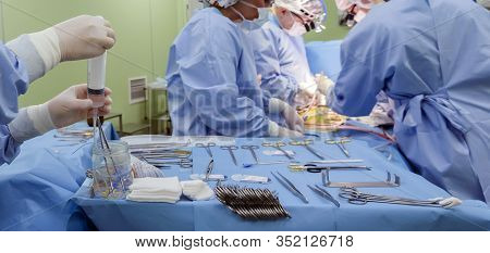 Surgical Instruments In Operating Room On Table.