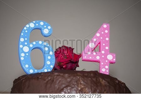 Numbers 64 On A Chocolate Cake. Blue 6 And Rose 4 Meaning 64 Years. Simple Chocolade With Red Flower