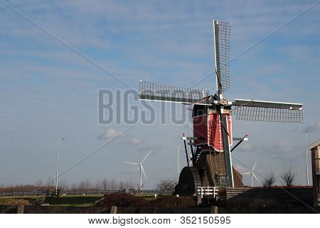 Red Colourd Old Four Corner Wooden Windmill At Zoeterwoude In The Netherlands