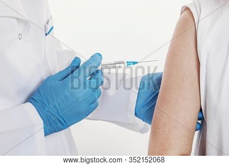 Close-up Of Doctors Hands In Blue Rubber Gloves Giving Shot To Patient, Isolated White Backgroud