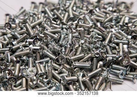 M6 Metal Screws Galvanized White In Bulk Closeup In The Studio