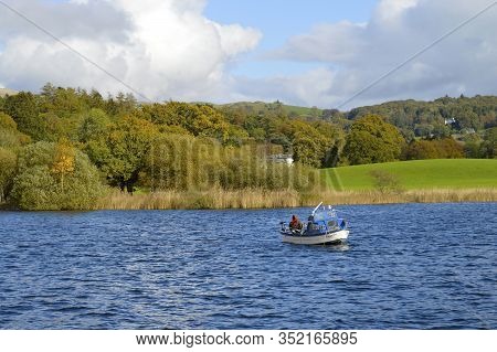 Lake Windermere, Cumbria, England, Uk - October 12, 2019 : A Man Fishing From A Boat On Lake Winderm