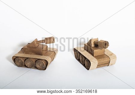 Two Toy Tanks Made By Children From Corrugated Cardboard Are Fighting. Toy Cardboard Tanks Isolated 