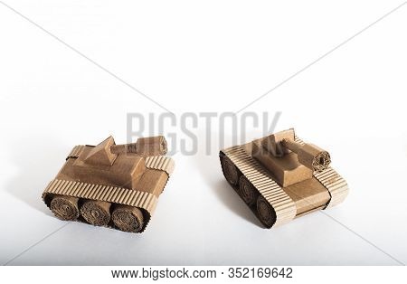Two Toy Tanks Made By Children From Corrugated Cardboard Are Fighting. Toy Cardboard Tanks Isolated 