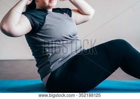 Fitness, Weight Loss, Home Workout. Overweight Woman Doing Sit-ups On Mat Indoors