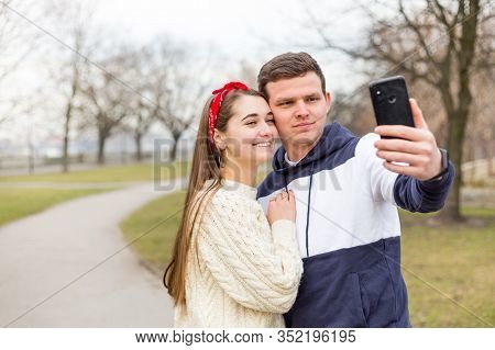Loving Cheerful Happy Couple Taking Selfie In The City. Capturing Happy Moments Together. Handsome M