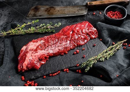 Raw Skirt, Machete Steak With Pink Pepper And Thyme. Black Background. Top View