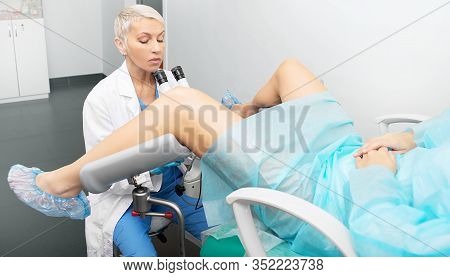 Colposcopy Of The Uterus. Gynecologist During The Examination Of The Cervix Of A Woman Patient