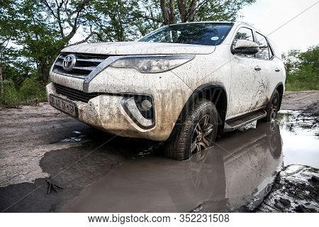 Moremi Game Reserve, Botswana - February 10, 2020: Off-road Car Toyota Fortuner In A Dirty Puddle.