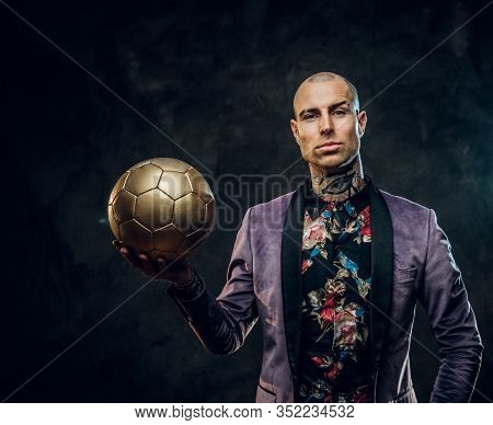Vivid, Successfull, Tattooed, Bald Male Model Posing In A Studio For The Photoshoot Wearing Fashiona