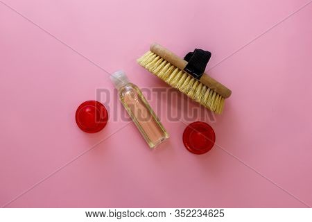 Spa Organic Brush For Dry Massage And A Bottle Of Body Oil On Pink Background. Cactus Brush And Jar 